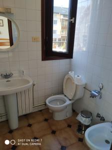 a bathroom with a toilet and a sink and a mirror at Hostal padornelo in Mondoñedo