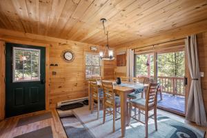 a dining room with a table and chairs at Log Home Retreat at Lake Winnipesaukee! in Meredith