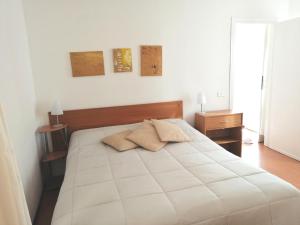 a bedroom with a white bed with two towels on it at Bellagio Centre in Bellagio