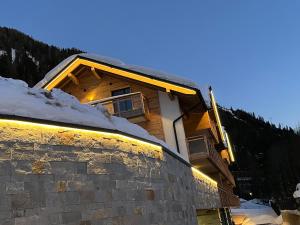 a building with snow on the side of it at ALPIUM - Luxusappartements in Flachau