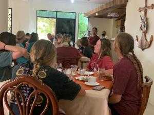 a group of people sitting at a table in a restaurant at Grand paraiso insular 2 in Puerto Baquerizo Moreno