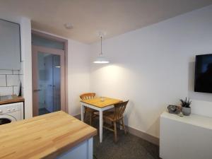 a kitchen with a table and a dining room at Surfer's Retreat in Chichester