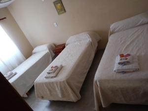 two beds in a room with towels on them at LOS CEDROS in Junín de los Andes