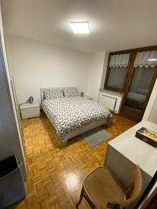 a bedroom with a bed and a table and chairs at Appartamento G&G in Pontechianale