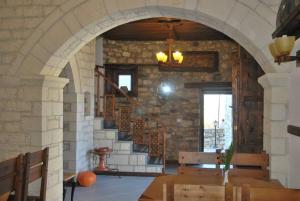 a room with a staircase in a stone building at Hotel Klea in Berat