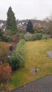 a view of a garden from a window of a house at Ferienwohnung Haske mit Wallbox in Gifhorn