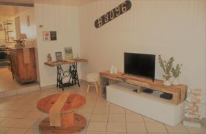 a living room with a flat screen tv on a table at La Belle Etap', gîte classé 3 étoiles in Étaples