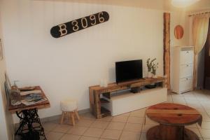 a living room with a tv on a wall at La Belle Etap', gîte classé 3 étoiles in Étaples