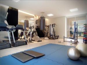 a fitness room with a gym with a blue rug at BIEN ÊTRE in Brasilia