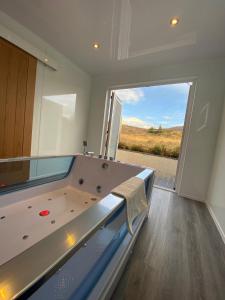 a pool table in a room with a large window at Highland Stays - Ben View Room & Jacuzzi Bath in Fort William