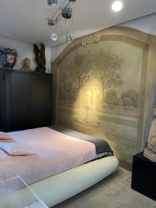 a bedroom with a bed with a painting on the wall at I sogni nel Cassetto Airport BLQ in Bologna