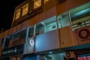 a building with a clock on the side of it at AC Residence - Behind Cititel Hotel in Kota Kinabalu