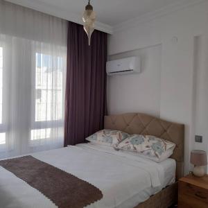 מיטה או מיטות בחדר ב-Seaside Apartments