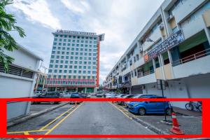 a parking lot with cars parked in front of a building at AC Residence - Behind Cititel Hotel in Kota Kinabalu