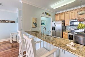 a kitchen with a counter top and a refrigerator at Sunny Carabelle Outdoor Haven with Beach and Pier in Big Blackjack Landing