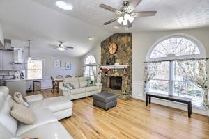 a living room with a couch and a fireplace at Immaculate Suwanee House with Pool and Game Room! in Suwanee