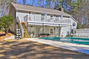 a house with a swimming pool in front of a house at Immaculate Suwanee House with Pool and Game Room! in Suwanee