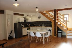 a kitchen and dining room with a table and chairs at Sainte Sabine en Dordogne in Castels