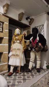 two people dressed in costumes standing in a room at Studio Cozy - In the Heart of Skyros Village in Skiros