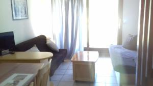 a living room with a couch and a table at Appartement 24 Les Chalets du Jardin Alpin in La Salle Les Alpes