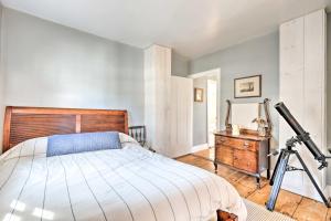 a bedroom with a bed and a telescope at Charming Sharon Dwelling with Deck and Fire Pit! in Sharon