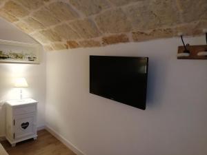 a flat screen tv hanging on a white wall at Casa Mina in Monopoli