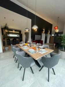 a dining room with a wooden table and chairs at dasKlet in Dugo Selo