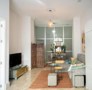 a living room with a couch and a table at Apartamento Alma Sevilla in Seville