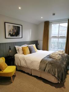 a bedroom with a large bed and a window at Blakeney House in Blakeney