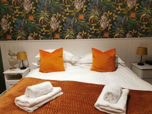 a bedroom with a bed with towels on it at Blakeney House in Blakeney
