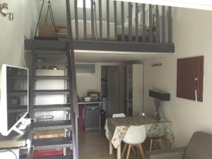 a living room with a spiral staircase in a room at Studio en Provence avec piscine in Graveson