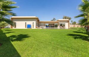 a house with a large lawn in front of it at Villa Green Paradise in Marrakesh