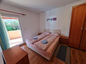 ein Schlafzimmer mit einem Bett und einem großen Fenster in der Unterkunft Apartments Spert in Umag