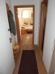 a hallway with a door open to a bedroom at Apartments Center KG in Kragujevac