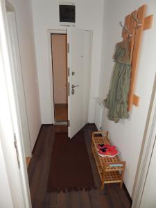 a hallway with a room with a table and a door at Apartments Center KG in Kragujevac