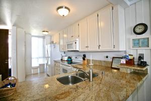 a kitchen with a sink and a counter top at D20 - Beachfront Delight in Oceanside