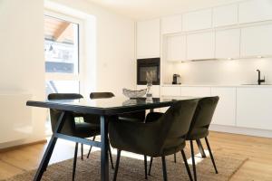 a dining room table and chairs in a kitchen at Kiechls Homebase - Adults only in Tarrenz