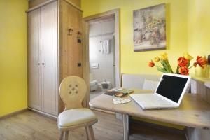 a laptop computer sitting on a wooden table in a room at Hotel Piccolo Mondo in Livigno