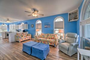 a large living room with blue walls and furniture at Waterfront Emerald Isle Home with Dock Access! in Emerald Isle