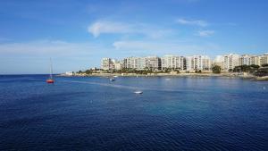 an aerial view of a large body of water with boats at The Diplomat Hotel in Sliema