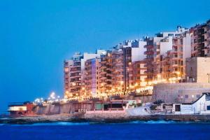 a large building with lights on top of it at The Diplomat Hotel in Sliema