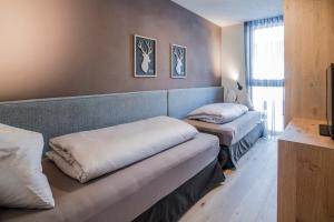 a room with two pillows on a couch in a room at Erika Suites & Lofts in Stanghe