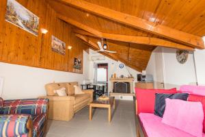 a living room with two couches and a fireplace at Tassos & Marios Apartments I in Laganas