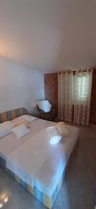 a bedroom with a large bed with white sheets at Vikula in Duće