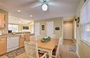 a kitchen and dining room with a table and chairs at Waterfront Townhome with Private Dock and Lake Views in Lake Ozark