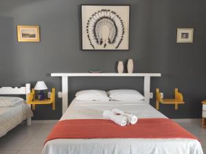 Säng eller sängar i ett rum på Pousada Brisa do Mar