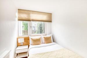 a bedroom with two beds and a window at Homely 4 Bedroom House in Brixton in London