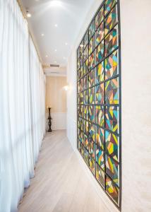 a wall of stained glass art in a hallway at Vintage Hotel in Tbilisi City