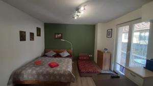 a bedroom with a bed and a large window at BIKE apartments 1 in Hodruša