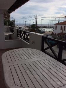 a balcony with a table and a view of a harbor at Marina in Nikiti
